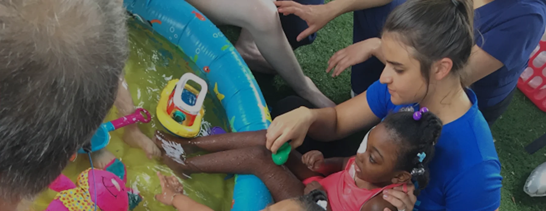 Patches about banner, Team members taking care of small girl