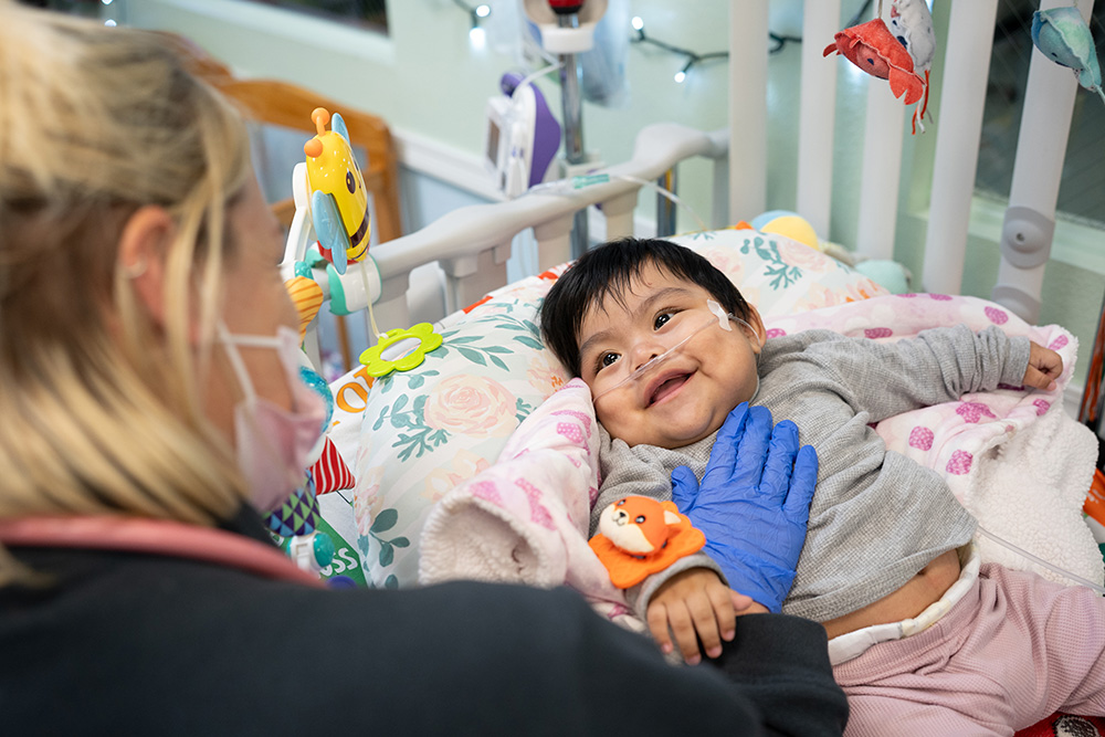 Baby smiling at the caregiver