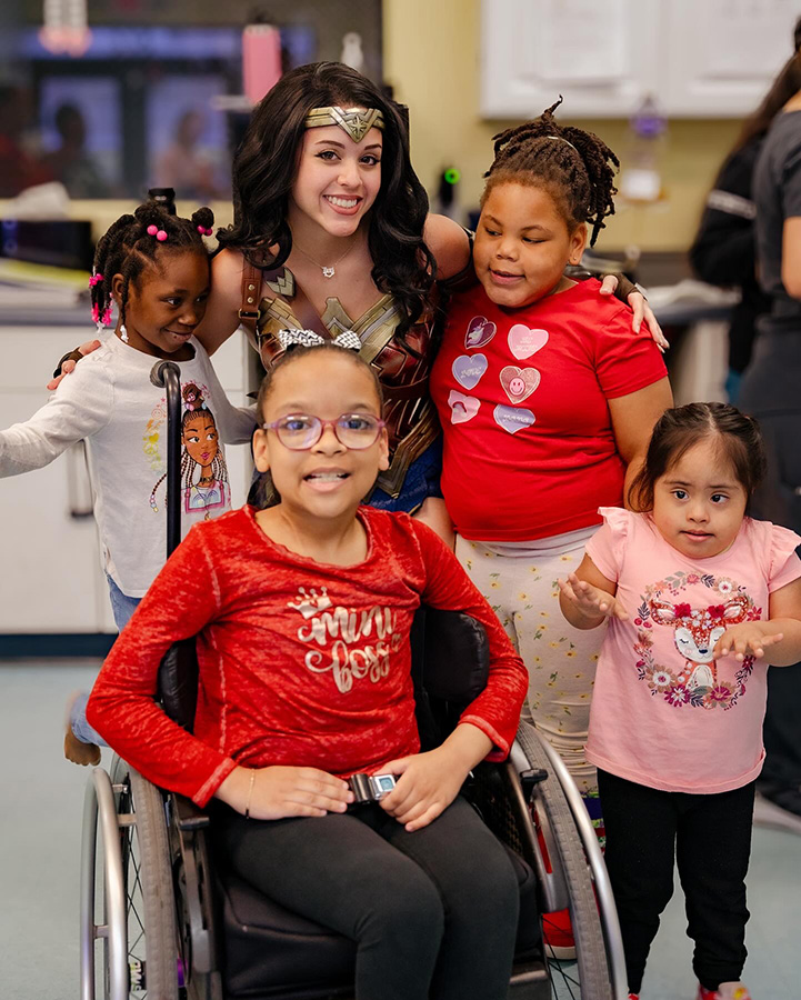 Children enjoying the company of wonder woman Children enjoying the company of wonder woman